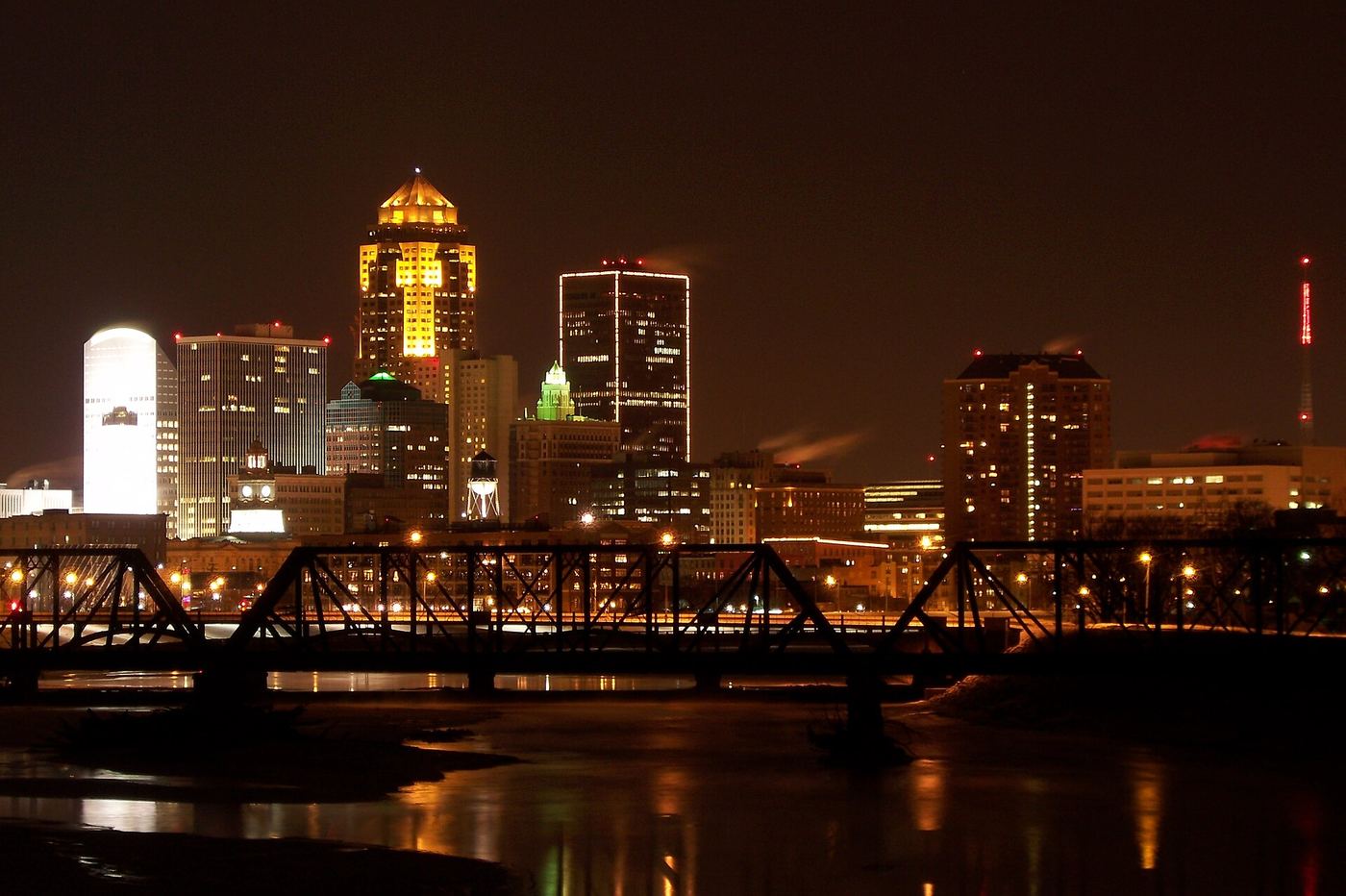 Downtown Des Moines skyline at night along the Des Moines River